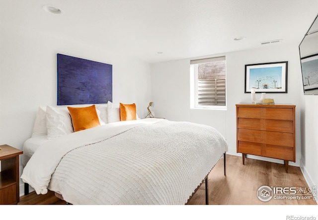 bedroom with wood-type flooring