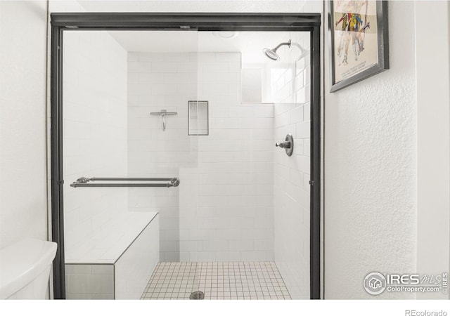 bathroom with toilet and walk in shower