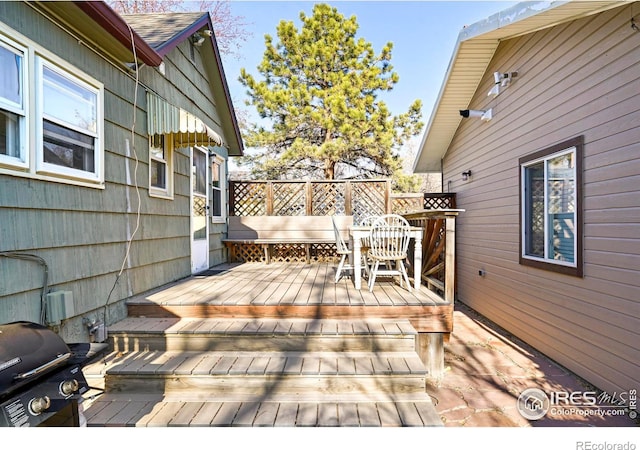 wooden terrace featuring a grill