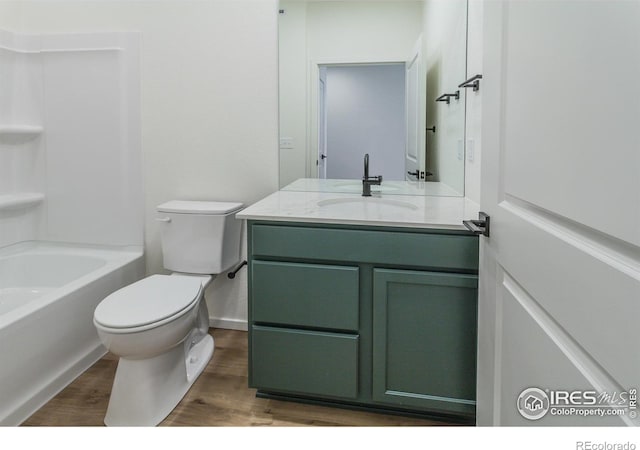 full bathroom featuring wood-type flooring, vanity, toilet, and shower / bathtub combination