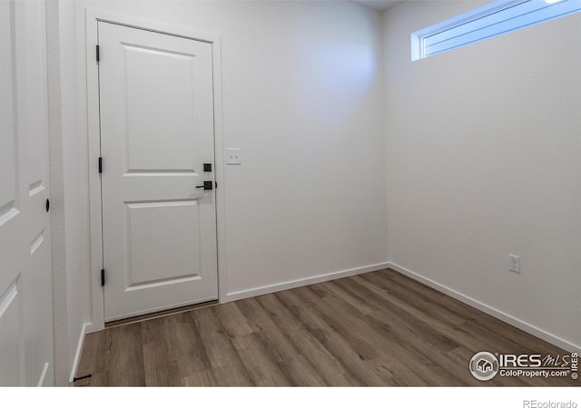 doorway with hardwood / wood-style flooring