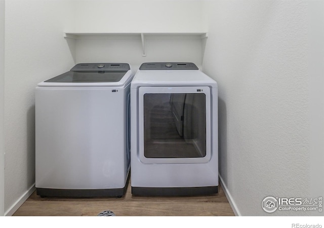 laundry area featuring dark hardwood / wood-style flooring and independent washer and dryer