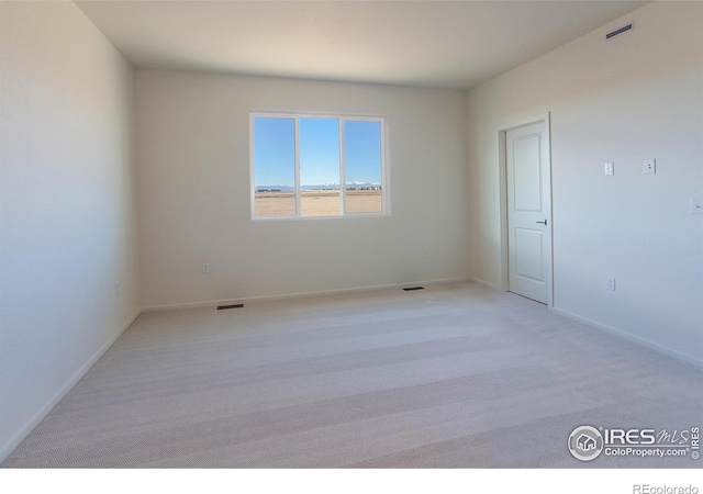 empty room featuring light colored carpet