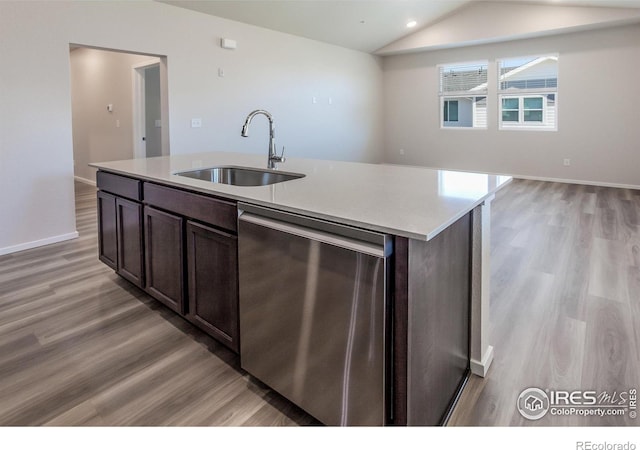 kitchen with dishwasher, dark brown cabinetry, sink, and a kitchen island with sink