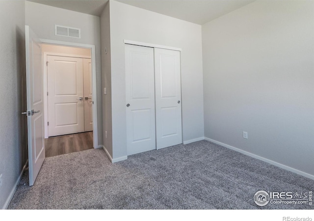 unfurnished bedroom featuring carpet flooring and a closet