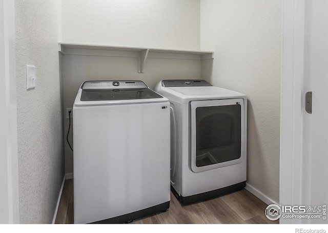 washroom featuring dark hardwood / wood-style floors and independent washer and dryer