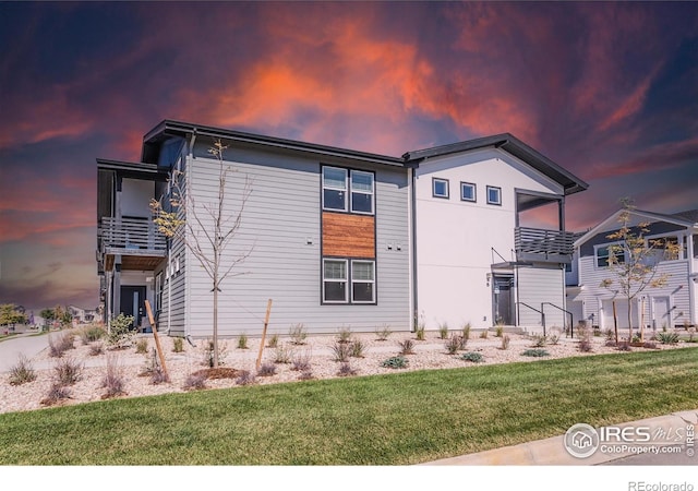 2120 Falling Leaf Dr Unit 8, Windsor, CO 80550 - back of house featuring a lawn and a balcony