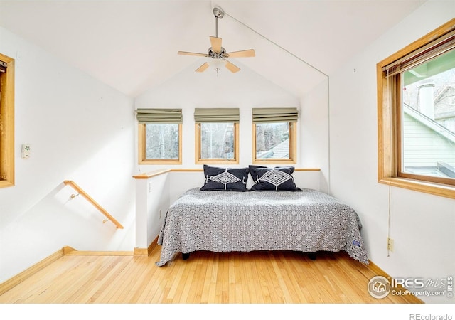 bedroom with hardwood / wood-style floors, vaulted ceiling, and ceiling fan