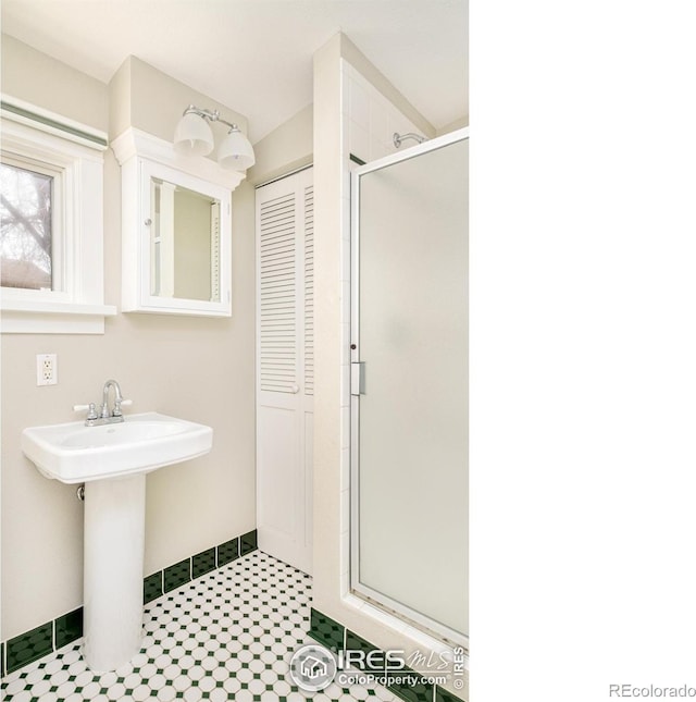 bathroom featuring sink and an enclosed shower