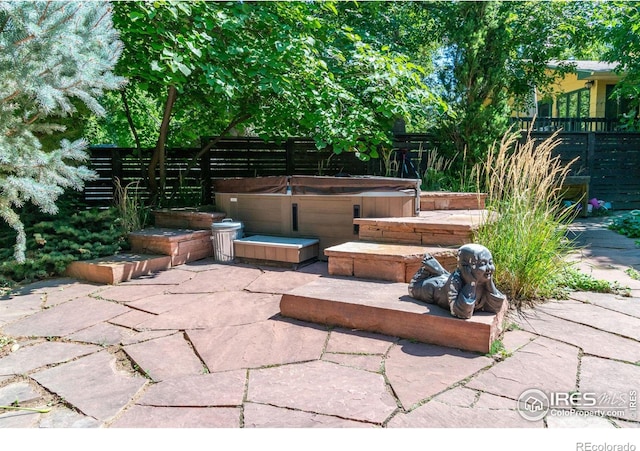 view of patio / terrace with a hot tub