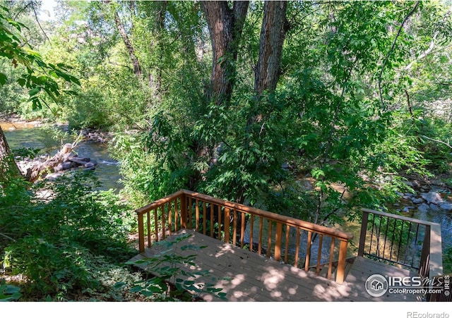 wooden deck featuring a water view