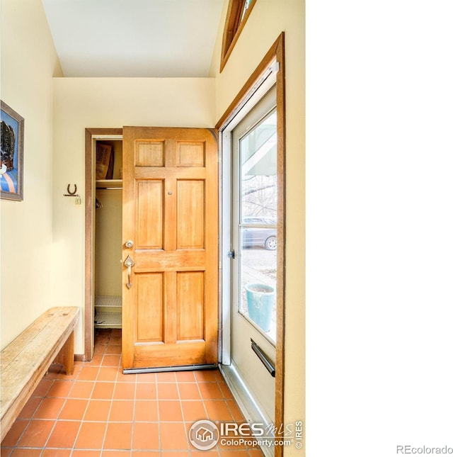 doorway with light tile patterned floors