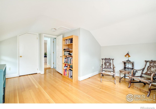 sitting room featuring lofted ceiling and hardwood / wood-style floors