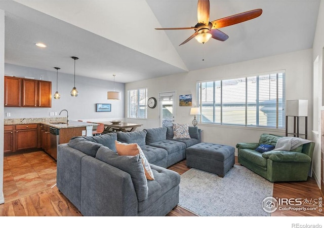 living area featuring lofted ceiling, light wood-style floors, a ceiling fan, and recessed lighting