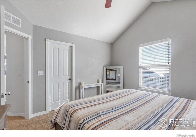 carpeted bedroom with lofted ceiling, baseboards, visible vents, and a ceiling fan