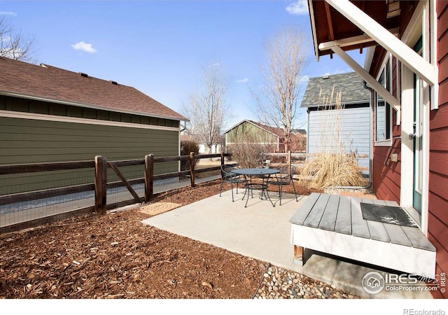 view of patio featuring outdoor dining space and fence