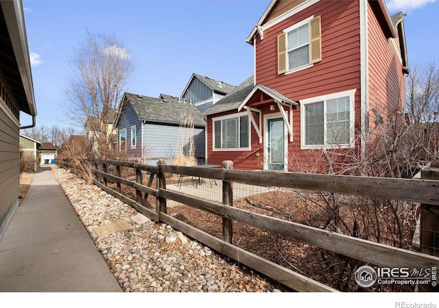 view of front of property featuring fence