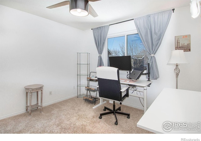 carpeted office space with ceiling fan