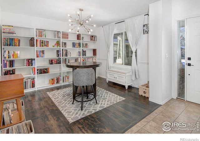 home office featuring hardwood / wood-style flooring and a notable chandelier