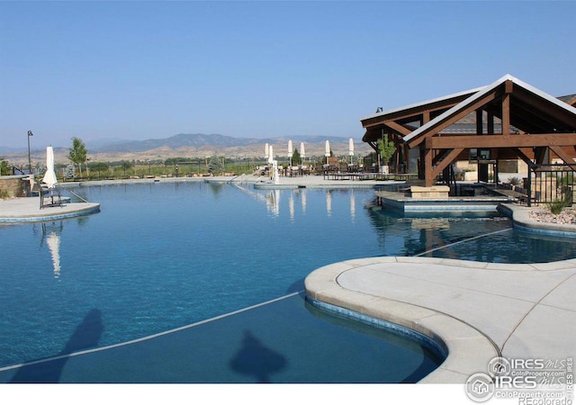 view of pool featuring a gazebo, a patio, and a water and mountain view