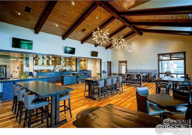 dining room with wooden ceiling, high vaulted ceiling, an inviting chandelier, light wood-type flooring, and beam ceiling