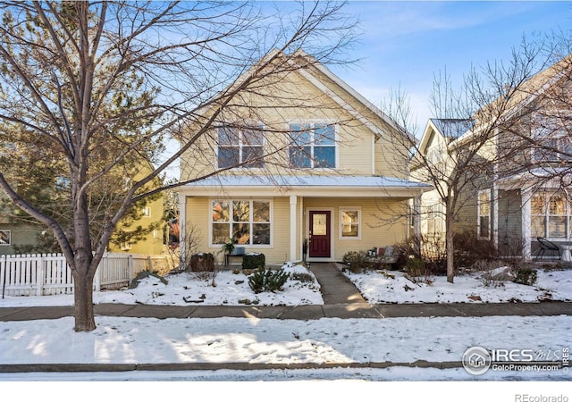 view of front of house with fence and covered porch