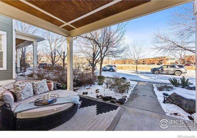 snow covered deck with covered porch