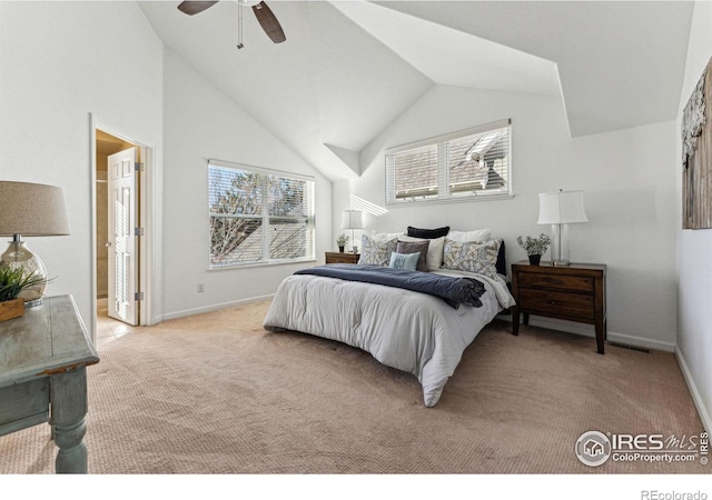 bedroom featuring ensuite bathroom, vaulted ceiling, ceiling fan, and light colored carpet