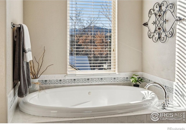 bathroom with tiled bath