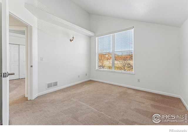 unfurnished room with light colored carpet