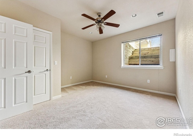 unfurnished bedroom featuring ceiling fan and light colored carpet