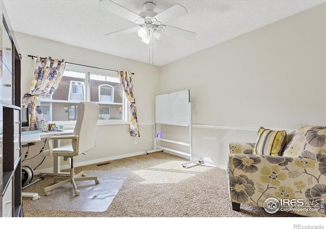 office space with ceiling fan, carpet floors, and a textured ceiling