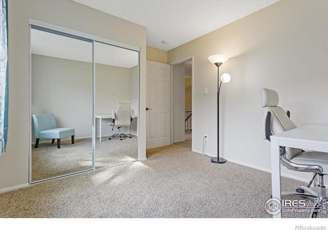 office with carpet floors and a textured ceiling