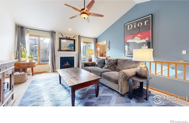 carpeted living room featuring a fireplace, ceiling fan, and lofted ceiling