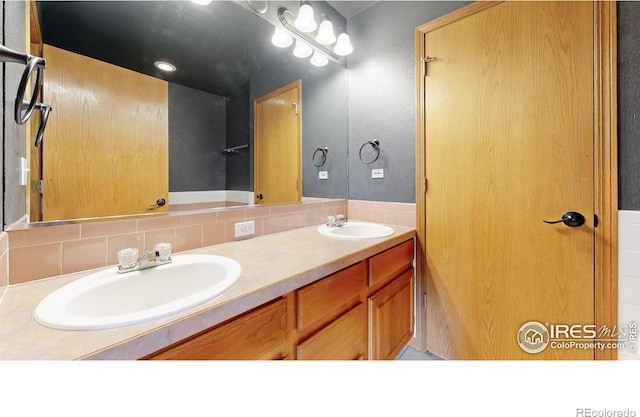 bathroom with decorative backsplash and vanity