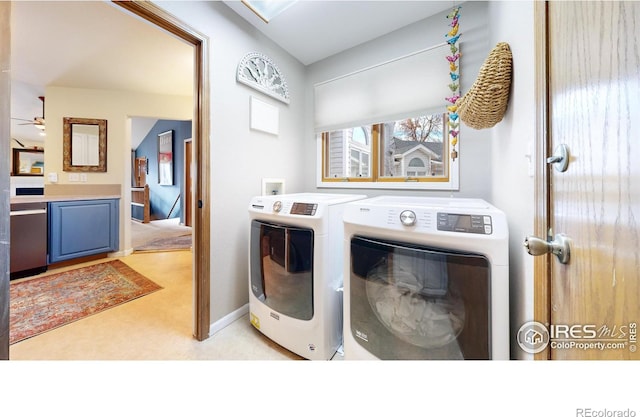 clothes washing area with separate washer and dryer, ceiling fan, and light colored carpet