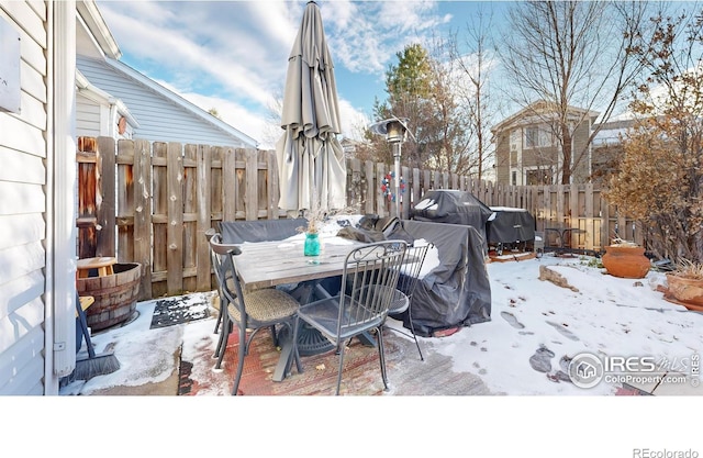 snow covered deck with grilling area