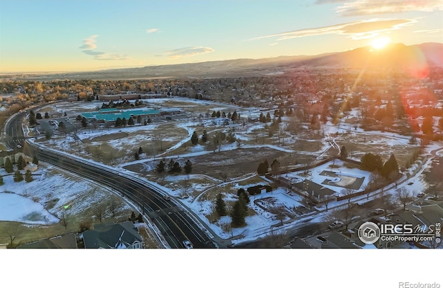 snowy aerial view featuring a mountain view