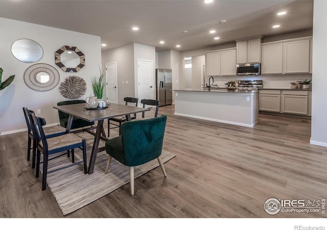 dining room with light hardwood / wood-style flooring and sink