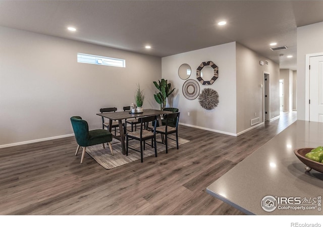 dining area with dark wood-type flooring