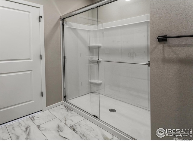 bathroom with a shower with shower door