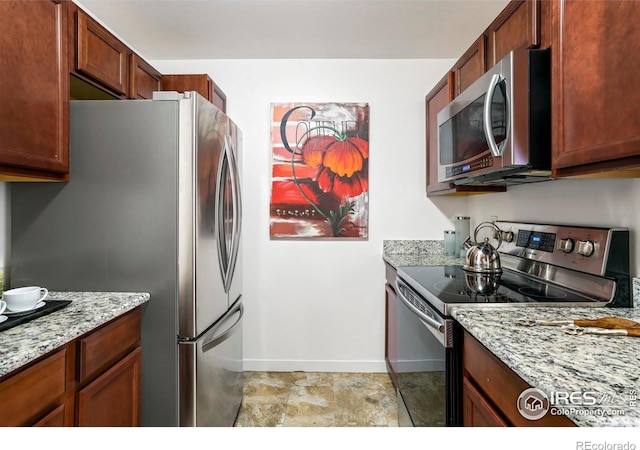 kitchen featuring light stone countertops and stainless steel appliances