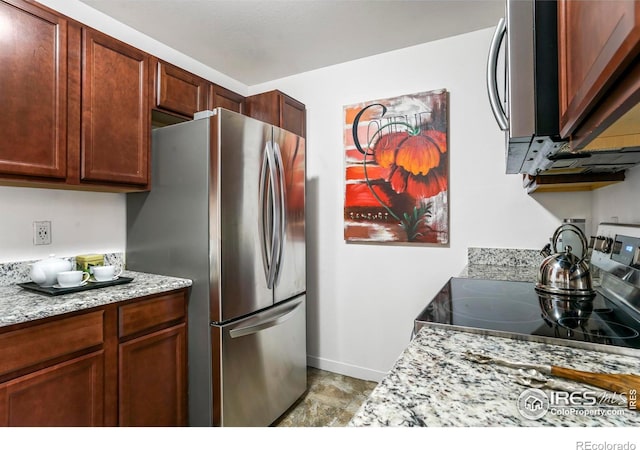 kitchen featuring light stone counters and appliances with stainless steel finishes