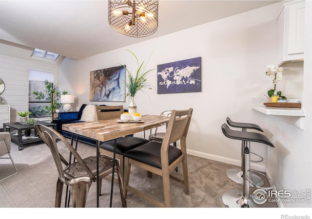 dining area with an inviting chandelier and carpet