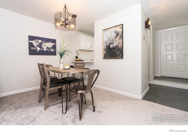 carpeted dining space with a chandelier