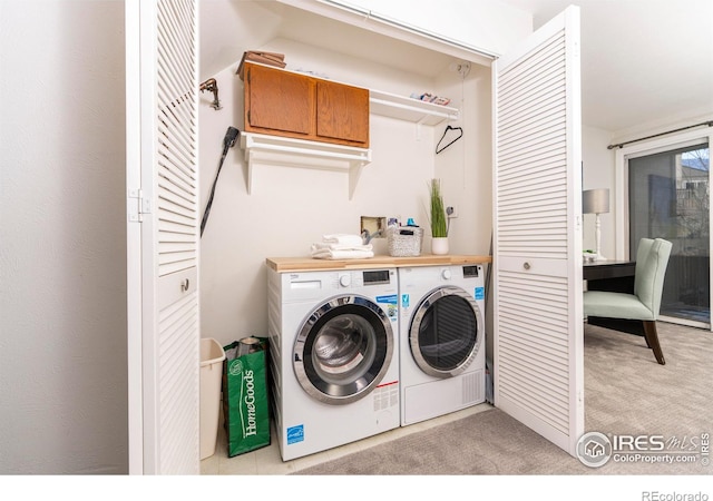 laundry room with washer and clothes dryer and light carpet