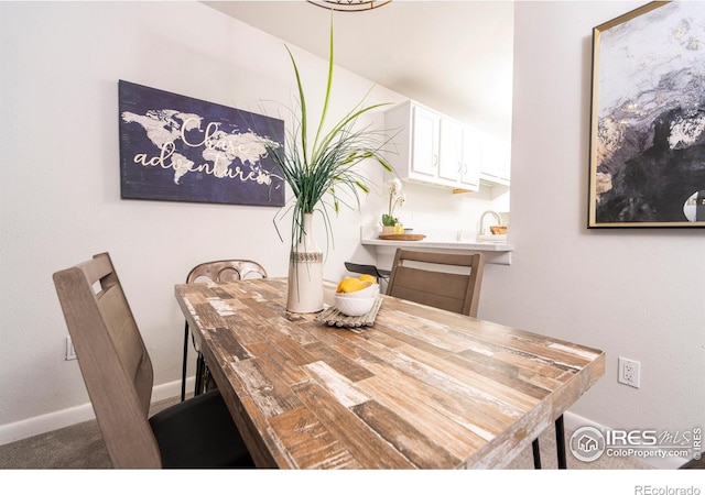 dining room featuring sink and carpet floors