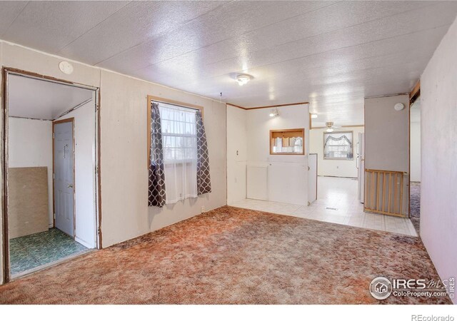 empty room featuring light carpet and ceiling fan