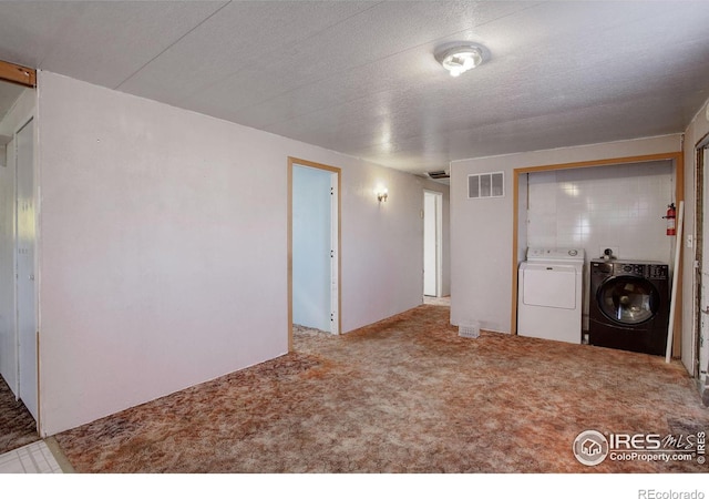 interior space with separate washer and dryer and a textured ceiling