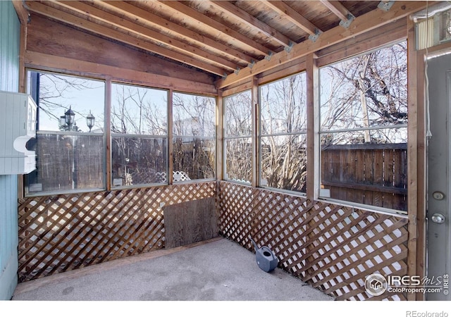 sunroom / solarium featuring vaulted ceiling with beams and wood ceiling